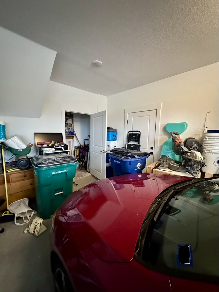 Cluttered garage before the TrueCraft transformation